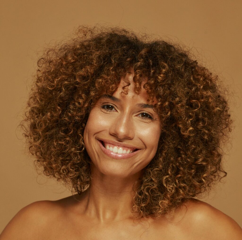 Close up of woman examining fine lines and skin texture concerns